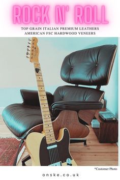 an electric guitar sitting on top of a wooden floor next to a black leather chair