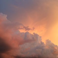 an airplane is flying in the sky at sunset