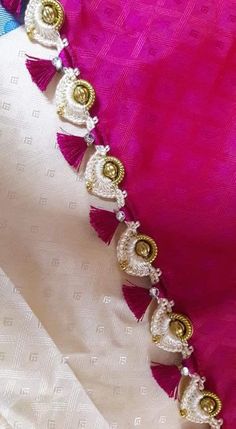 white and pink saree with gold work on the border