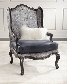 a gray chair with a white pillow on it's back and some black legs