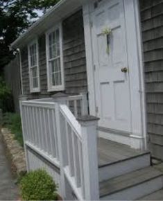 a white door and steps leading to a house