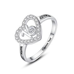 an open heart shaped ring with the words love is in the air and diamonds on it