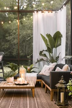 a living room filled with furniture and lots of plants