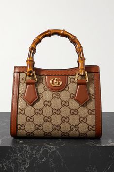 Gucci's 'Diana' bag is part of the 'Love Parade' collection, which revives Old-Hollywood glamor. Crafted in Italy, it's made from canvas-jacquard that's detailed with crystal-dusted 'GG' motifs and trimmed with leather. The bamboo top handles have been a brand signature since the '40s. Attach the shoulder strap to go hands-free. Hand Bag Gucci, Luxury Purses Gucci Bags, Gucci Bamboo Bag, Gucci Bags Handbags, Gucci Diana, Gucci Products, Hollywood Glamor, Multi Colored Bag, Luxury Bags Collection