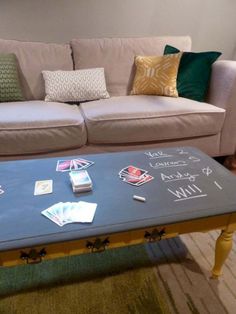 a coffee table with writing on it in front of a couch