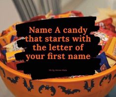 a bowl filled with lots of candy next to a sign that says name a candy that starts with the letter of your first name