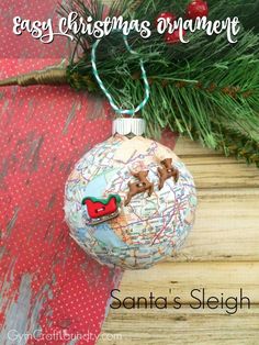 a christmas ornament hanging from a tree branch with the words easy christmas ornament santa's sleigh