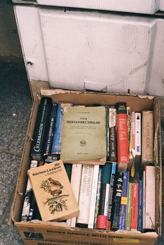 a box full of books sitting on the ground