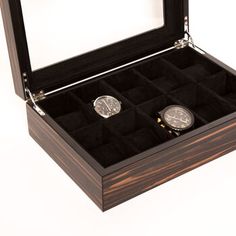 two watches in a wooden box on a white background