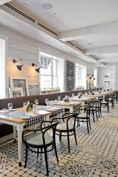 an empty restaurant with long tables and chairs