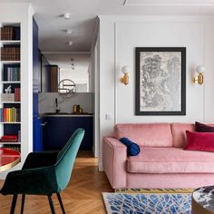 a living room filled with furniture next to a dining room table and bookshelf