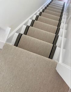 Chalk Herringbone carpet fitted to the stairs as a stair runner and fully fitted on the landing area. The stairs are painted white and the runner is edged in a black and cream stripe tape. Stair Runner Hallway, Staircase Ideas Carpeted Runner, Herringbone Sisal Stair Runner, Stair Runner Carpet Top Of Stairs, Herringbone Runner Stairs, Cream And Black Hallway, Black And Cream Hallway, Striped Stair Carpet, Stairs Runner Carpet