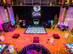 the dance floor is lit up with colorful lights and sparkles for an entertainment event