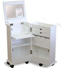 an open white cabinet with drawers and a mirror