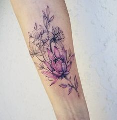 a woman's arm with a flower tattoo on it