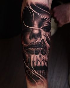 a man with a skull tattoo on his arm