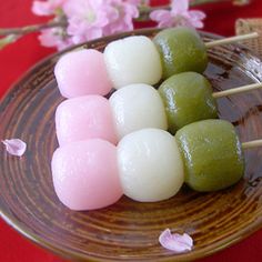 some food is on a brown plate with pink and white flowers in the back ground