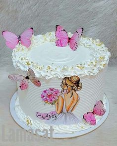 a white cake decorated with pink butterflies and a woman holding a bouquet of flowers on top