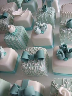 there are many square cakes decorated with blue ribbons and bowknots on them