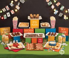 an assortment of snacks are on display at a movie themed birthday party or baby shower