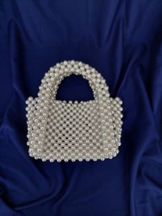 This mini pearl bead wedding bag is completely handmade. This and other pearl bags are all made of luxury plated pearl beads and will not fade or fray. This handmade pearl bead bag will be a good option to use at your weddings, engagements and special occasions. If you are looking for a different gift for your loved ones, this top handle bead bag is a good option for you. For longer use, protect the beaded bride purse from bumps, drops and direct sunlight.  Details: Completely handmade and caref Beaded Pearl Bags For Events, Pearl Beaded Evening Bag, Pearl Beaded Bags For Events, Wedding Pearl Beaded Bags, Bride Purse, Pearl Begs, White Pearl-embellished Bags, Pearl Bags, Elegant Pearl Beaded Bag