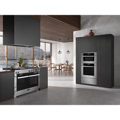 a modern kitchen with an oven, stove and dining table in the backround