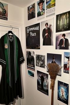 a harry potter costume hangs on the wall next to a coat rack with posters all over it