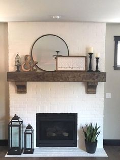 a living room with a white brick fireplace and potted plants on the mantel