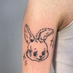 a woman with a rabbit tattoo on her arm