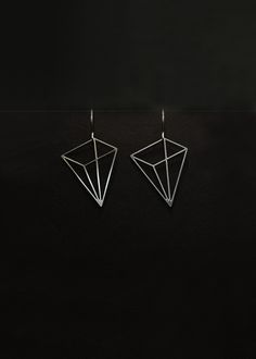 The Pyramid earrings are part of The Edges Collection. Inspired by a simple line drawing, the two-dimensional pyramids create the illusion of geometry in three dimensions. The visual ambiguity results in wearable art that is light and minimal, understated yet unique. Available as either 14K gold-plated with a gold ear wire or stainless steel with a stainless steel ear wire. The Edges collection is created through a process of photochemical etching. Minimalist Triangle Jewelry For Pierced Ears, Minimalist Triangle Jewelry, Minimalist Triangle Jewelry For Formal Occasions, Modern Geometric Earrings For Pierced Ears, Minimalist Silver Pyramid Jewelry, Minimalist Linear Earrings For Formal Occasions, Minimalist Diamond-shaped Earrings For Gift, Modern Geometric Linear Earrings For Gifts, Modern Geometric Pierced Earrings