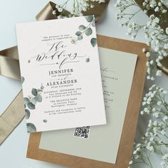 the wedding stationery is laid out on top of each other with ribbon and flowers