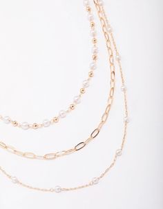 For a timeless addition to your outfit, style this gold-toned necklace. This layered necklace features three rows of varying chains, decorated with mini pearls for a sophisticated touch. Dimensions: Chain Length 48cm Weight: 18g | Lovisa Gold Fine Station Pearl Necklace Multi-strand Metal Necklace With Pearl Chain, Gold Multi-strand Pearl Necklace With Adjustable Chain, Gold Pearl Necklace For Layering, Gold Multi-strand Pearl Necklace, Gold Pearl Beaded Chain Layered Necklace, Gold Pearl Layered Necklace With Beaded Chain, Gold Multi-strand Pearl Layered Necklace, Gold Pearl Multi-strand Layered Necklace, Gold Multi-strand Pearl Chain Necklace