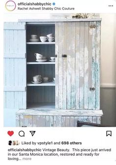 an old cabinet is painted white and has dishes in it on the bottom shelf,