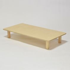 a small wooden table with no legs on the top and one leg missing from it