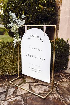 a welcome sign sitting on top of a metal stand