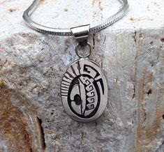 "Featured is a Native American Bear pendant with symbols of water waves and detailed with hand stamped work. The Bear is one of the most powerful symbols amongst Native Americans. The Bear represents Strength, Power, Medicine to heal and the Courage and Wisdom to guide. The water wave symbol is an endearing part of \"all\" life's eternal flow. The Bear pendant was handmade by Calvin Peterson affiliated with the Navajo tribe, well known for his clean detail in Navajo overlay. The pendant was made Symbolic Etched Sterling Silver Jewelry, Silver Stamped Oval Pendant Necklace, Silver Stamped Oval Pendant Jewelry, Sterling Silver Oval Pendant Necklace, Stamped Amulet Pendant Jewelry, Symbolic Stamped Pendant Jewelry, Traditional Sterling Silver Necklace, Artisan Engraved Oval Pendant Jewelry, Traditional Etched Oval Jewelry