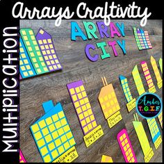 an array of colorful paper cutouts on a wooden surface with the words array city