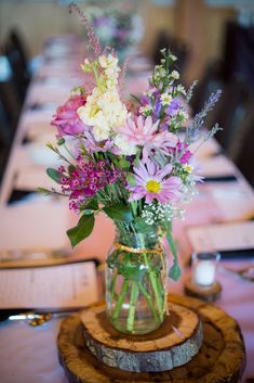 a vase filled with flowers sitting on top of a table