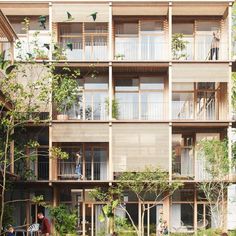 an apartment building with lots of balconies and plants on the balconys,