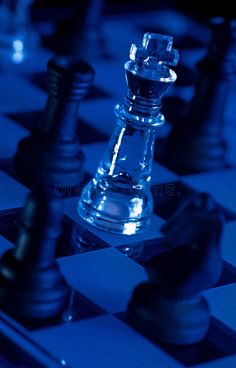 chess pieces on a blue and black checkerboard board royalty images, stock photos