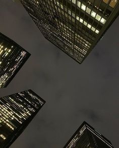 looking up at skyscrapers in the city at night