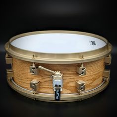 a close up of a wooden drum on a black background