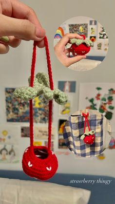 a hand holding a small crocheted red object