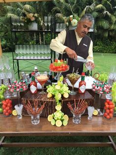 a man standing in front of a table filled with food