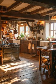 an old fashioned kitchen with wooden floors and lots of pots hanging on the wall above the stove