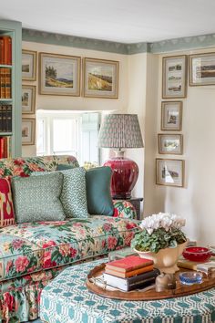 a living room filled with furniture and lots of books on the shelves in front of it