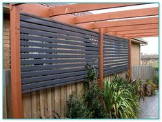 an outdoor patio with wooden pergols and potted plants on the side walk