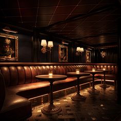 a dimly lit restaurant with leather booths and paintings on the wall, along with candles