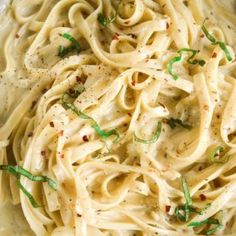 a bowl filled with pasta and garnished with parsley on the top side