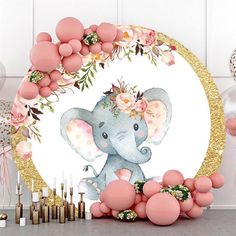 an elephant surrounded by balloons and flowers on a table with gold foil confetti